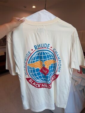 Rhude Cream Graphic Tee with Blue Globe & Orange Wings